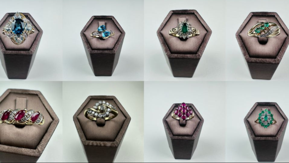 Gold ring with colorful gemstones on a white background